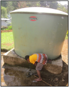 A student drinking water from the installed water tanks after using the toilet. The tanks were relocated by the school to its administration block. 